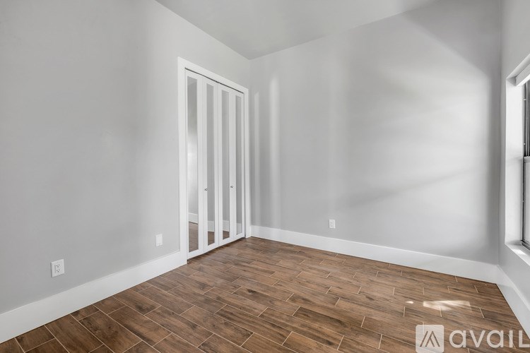 A room with a wooden floor and white walls.