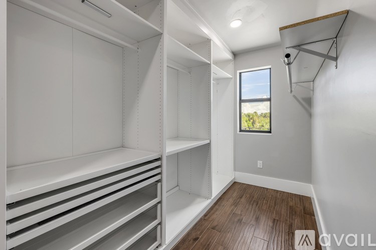 Empty white shelving unit in a room with a window.