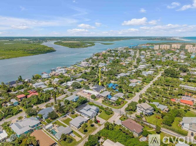 A bird's eye view of a residential area with a river running through it.