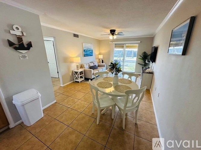 A living room with a white table and chairs.