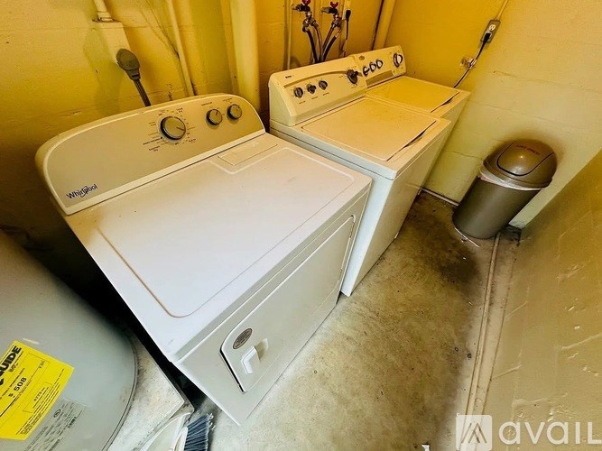 A white washing machine and dryer in a small room.