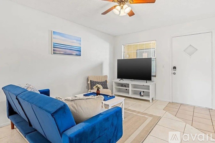 A living room with a blue couch and a television.