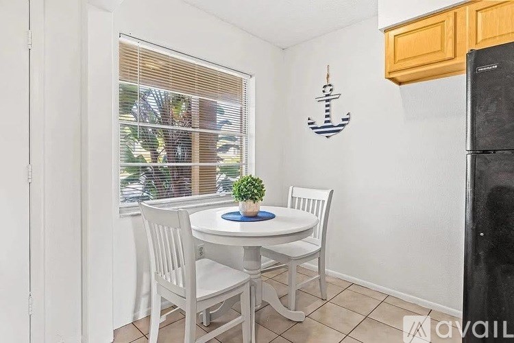 A small dining room with a table and chairs.