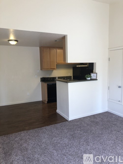 A kitchen area with a black countertop and a white cabinet.