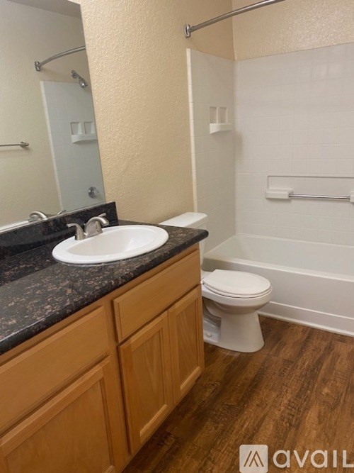 A bathroom with a toilet, sink, and shower.