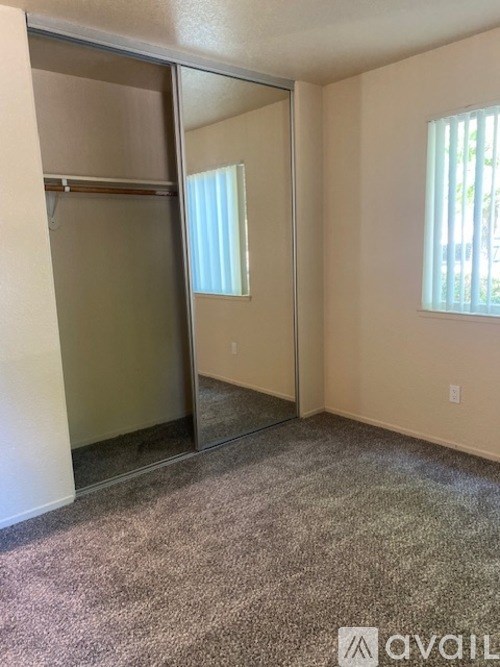 A room with a carpeted floor and a glass door.