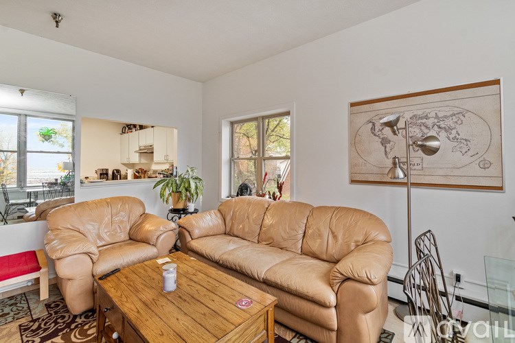 A room with a view of the ocean through large windows.