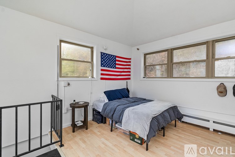 A room with a window and wooden flooring.