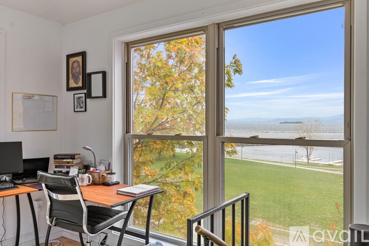 A room with a window and wooden flooring.