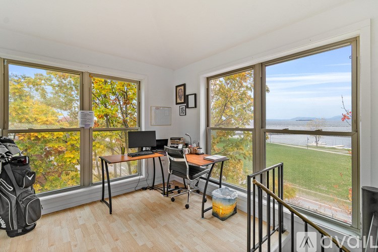 A room with wooden flooring and a window.