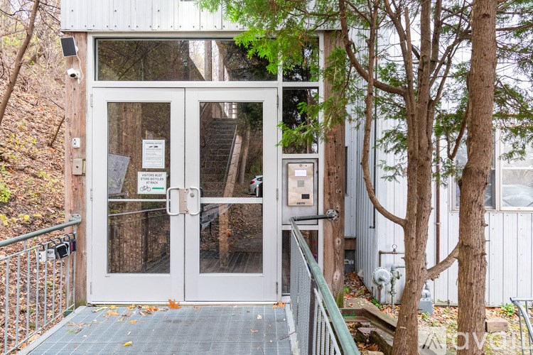 A white building with a glass door and a sign on it.