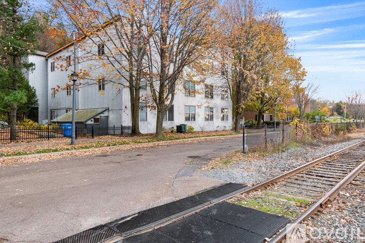 A railway track runs through the middle of a paved area.