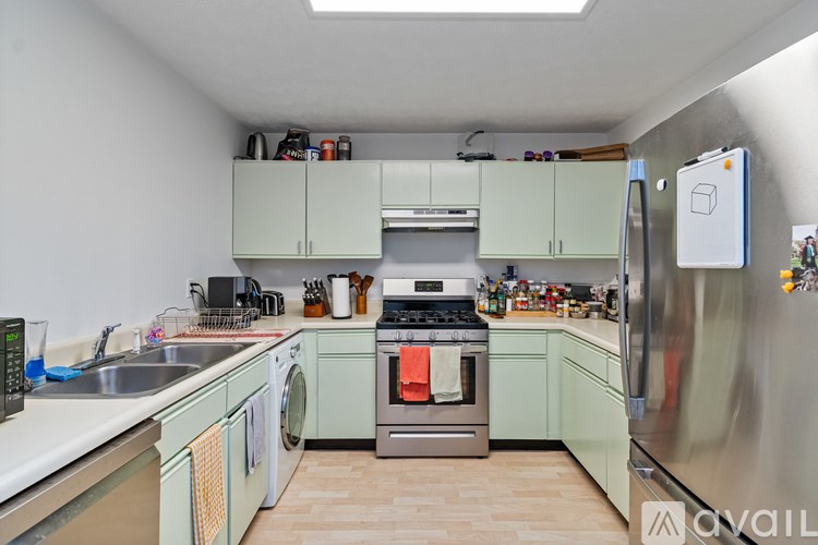 A room with a large window showing trees outside.