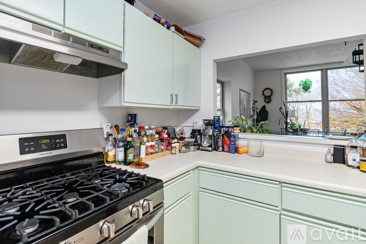 A kitchen with a washing machine and a stove top.