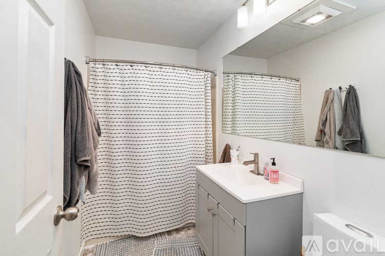 A white toilet sits next to a sink in a bathroom.