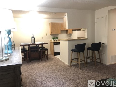 A kitchen area with a dining table and chairs.
