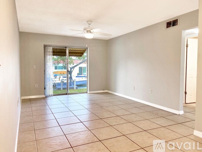 A room with tiled flooring and a ceiling fan.