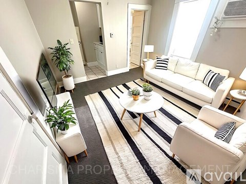 A living room with a white couch and a coffee table.