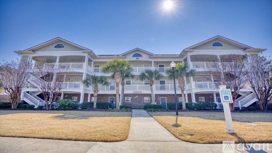 A sunny day at a residential complex with a clear blue sky.