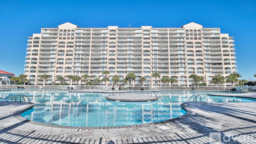 A large building with a pool in front of it.