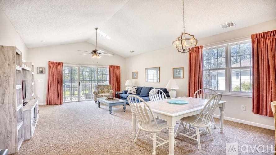 A living room with a dining table and chairs.