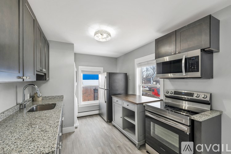 A kitchen with granite countertops and stainless steel appliances.