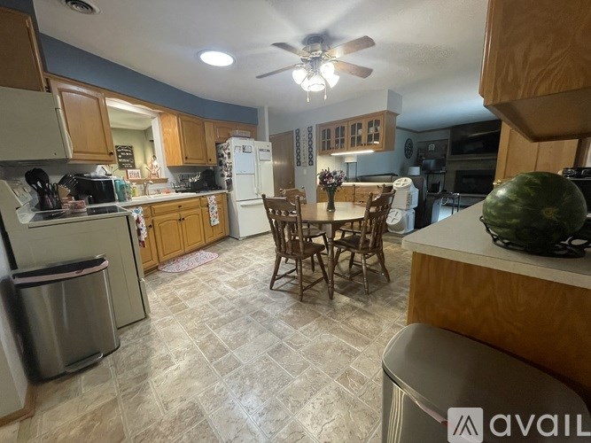 A kitchen with a table and chairs in the middle of the room.