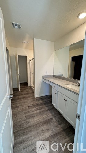A bathroom with a sink and mirror.