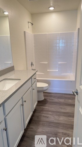 A bathroom with a toilet, sink, and bathtub.