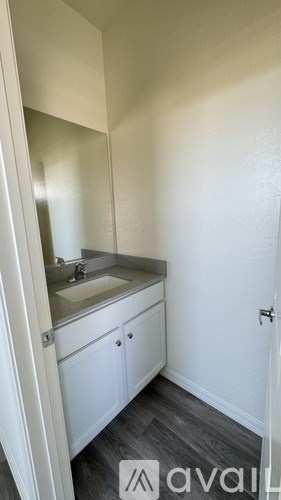 A small bathroom with a sink and mirror.