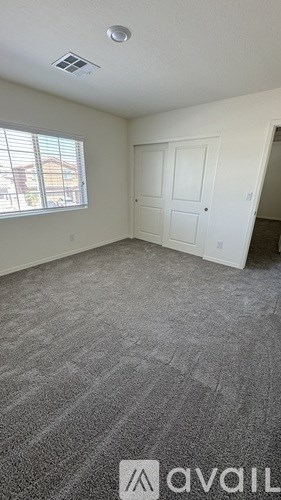 A room with a carpeted floor and a door.