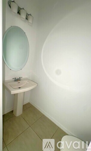 A white sink in a small bathroom.