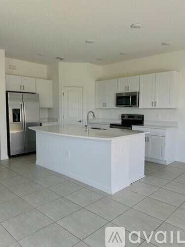 A kitchen with white cabinets and a central island.
