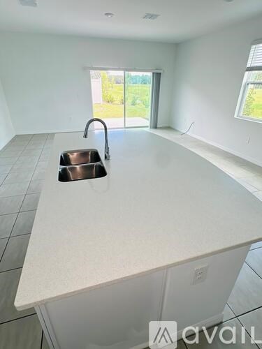 A kitchen with a sink and a window.