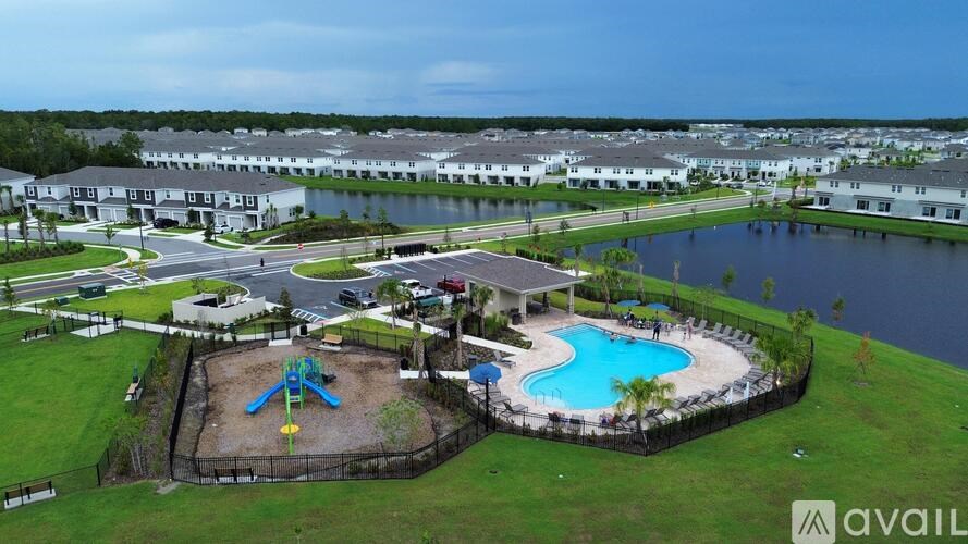 A bird's eye view of a community with a playground and a pool.