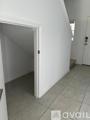 A white door is open to a hallway.