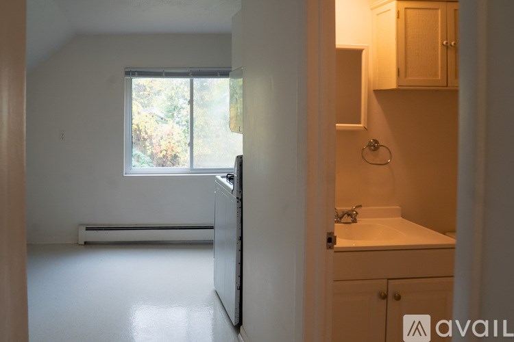 A bathroom with a sink and a window.