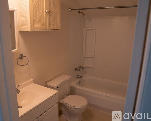 A small bathroom with a toilet, sink, and bathtub.