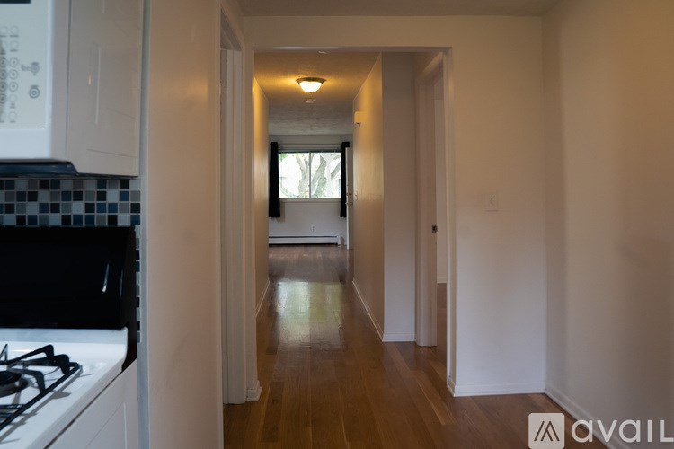 A long hallway with a light at the end.