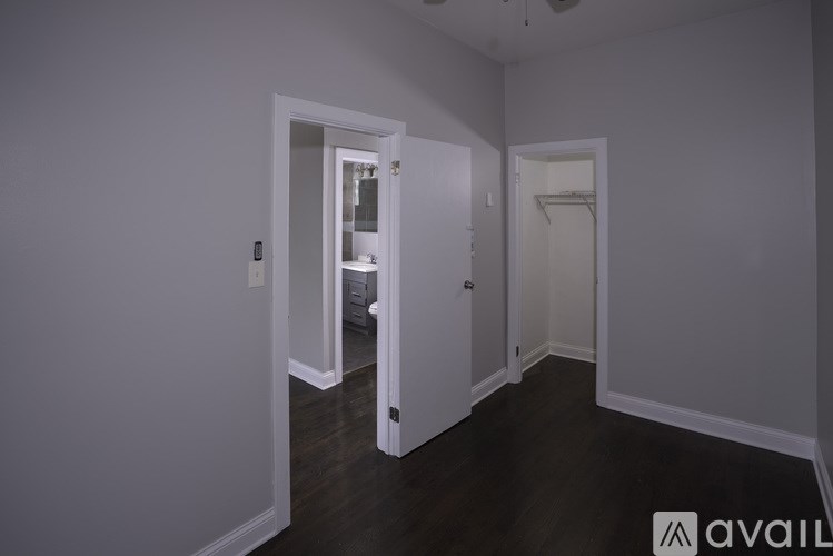 A room with wooden floors and a chandelier.