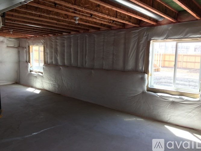 A room with a white insulation covering the walls and ceiling.
