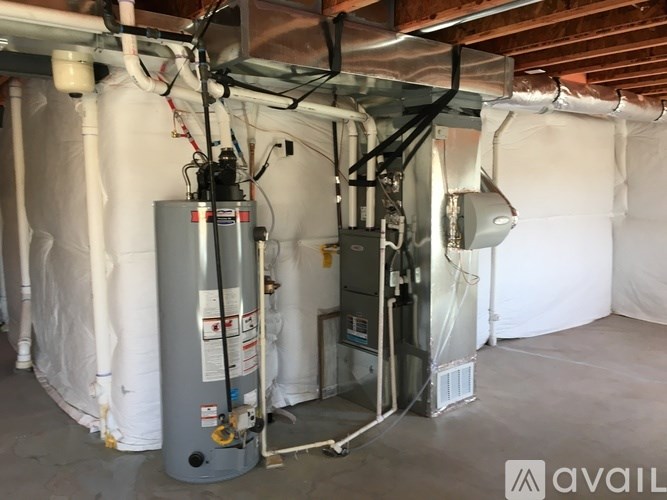 A room with a furnace and air conditioner unit installed.