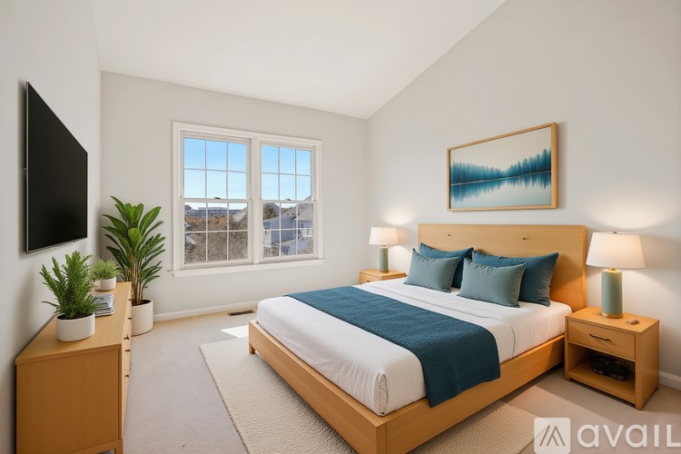 A bedroom with a large bed, a flat screen TV, and a window overlooking a cityscape.