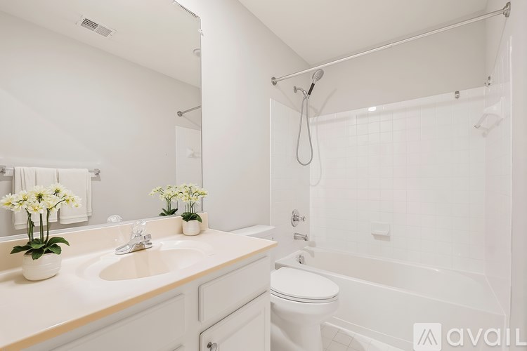 A white bathroom with a sink, toilet, and bathtub.