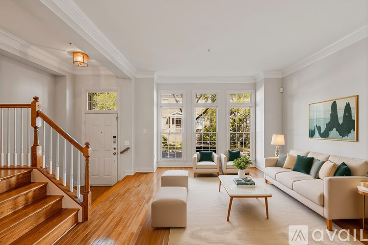A living room with a staircase and a couch.