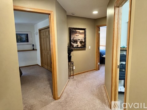 A living room with a painting on the wall and a carpet on the floor.