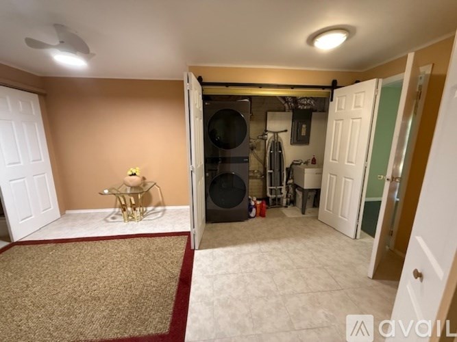 A room with a rug, a table, and a bicycle.