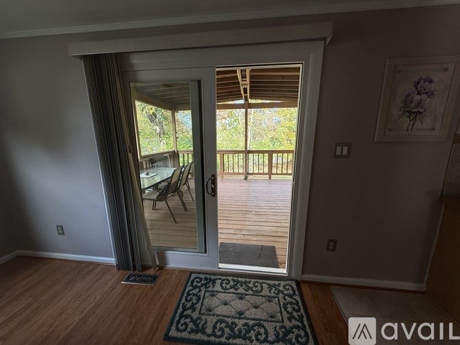 A room with a sliding glass door leading to a deck.