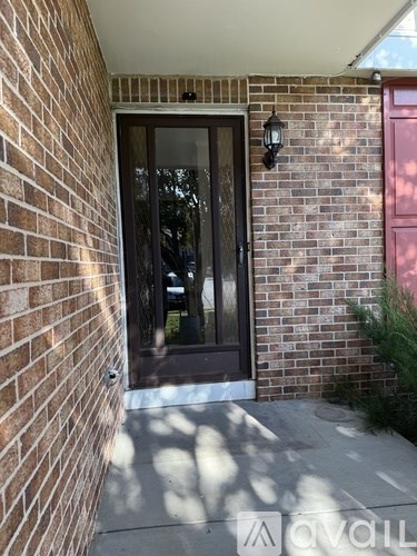 A glass door is on the brick wall.