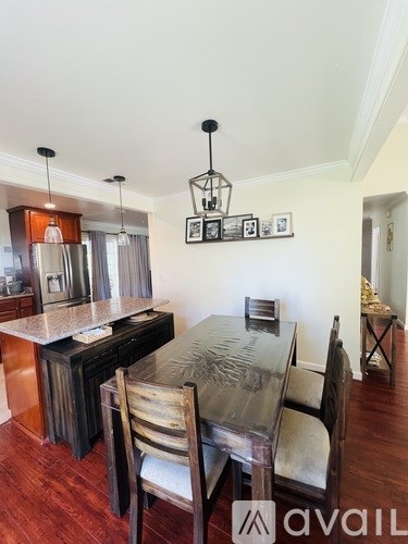A kitchen with a table and chairs in the middle of the room.